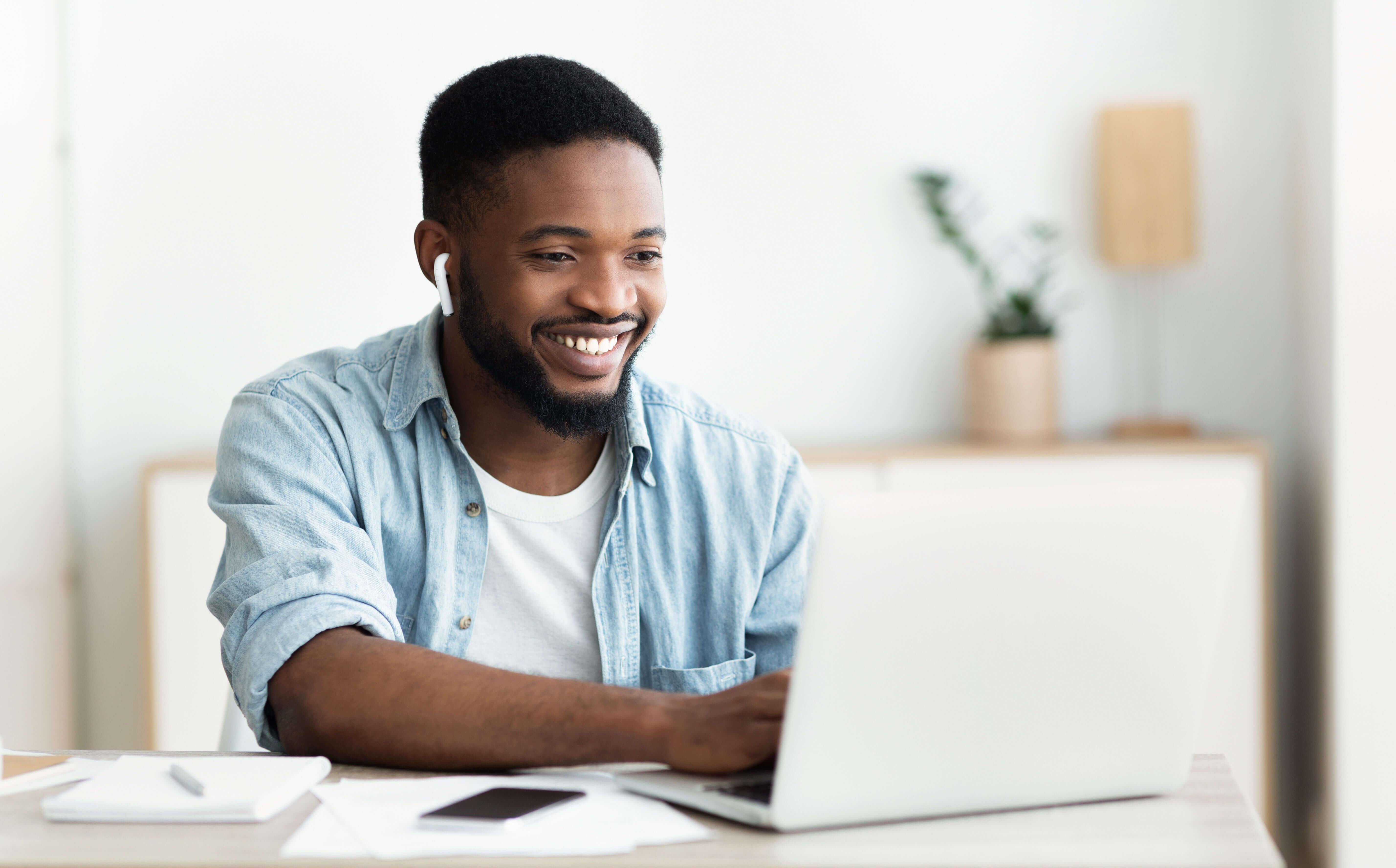man smiling using laptop